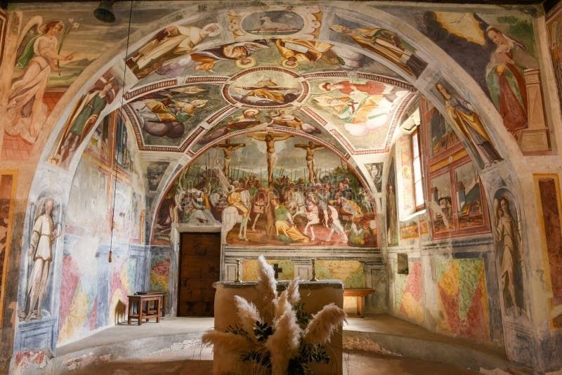 Interior of a richly frescoed medieval church with biblical scenes